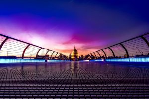 Captivating view of London's Millennium Bridge at sunset with St. Paul's Cathedral in the background.