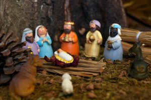 Clay nativity scene depicting baby Jesus, Virgin Mary, and Three Wise Men with figurines and animals.