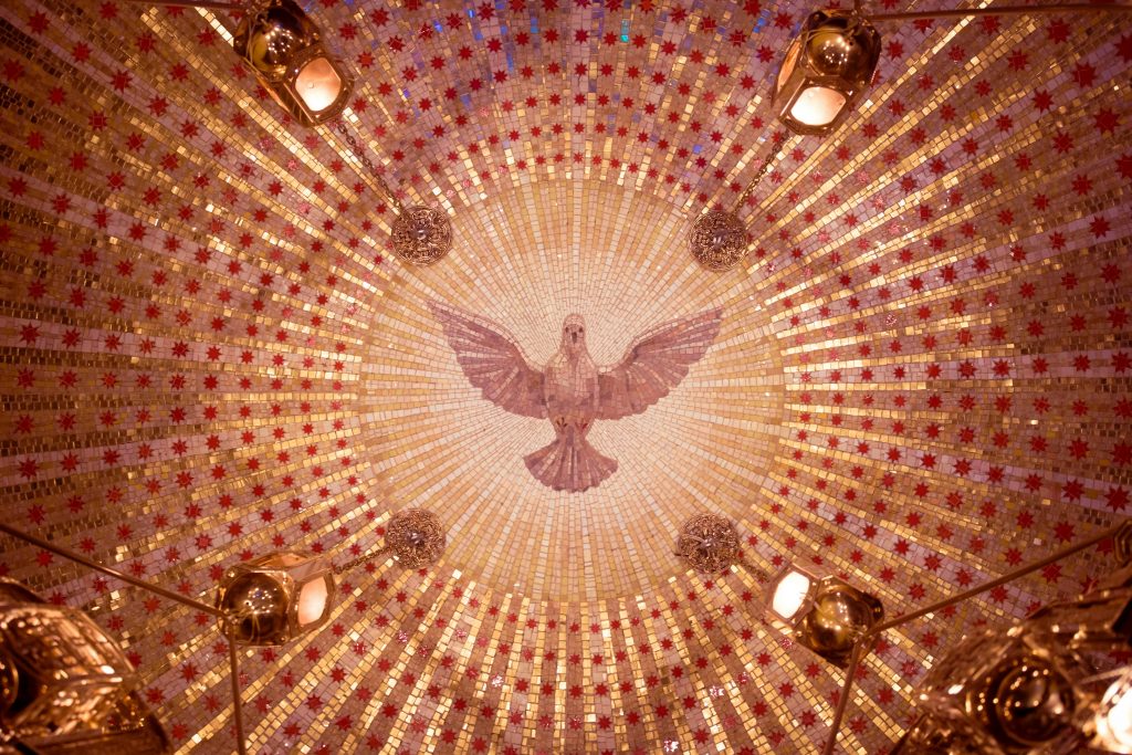 Intricate dome mosaic featuring a central dove design with gold and red patterns.