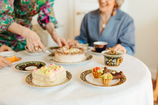 A delightful afternoon tea setting with cakes and pastries on a beautifully set table.
